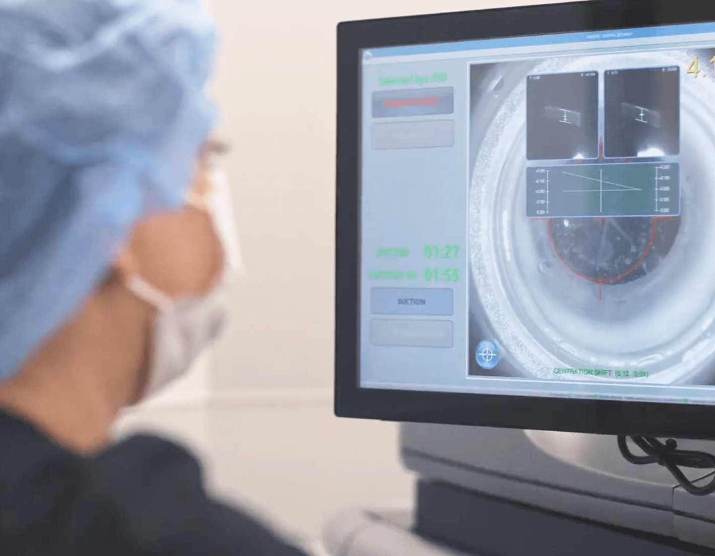 Surgeon reviewing eye scan on monitor