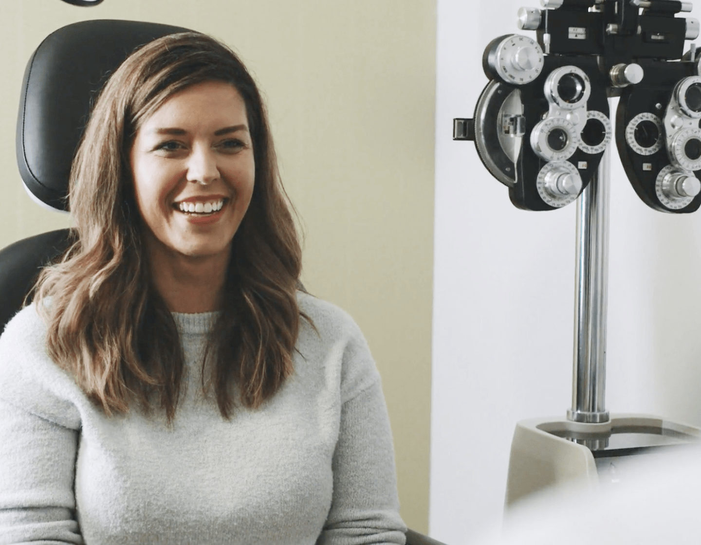 Woman smiling in eye exam chair