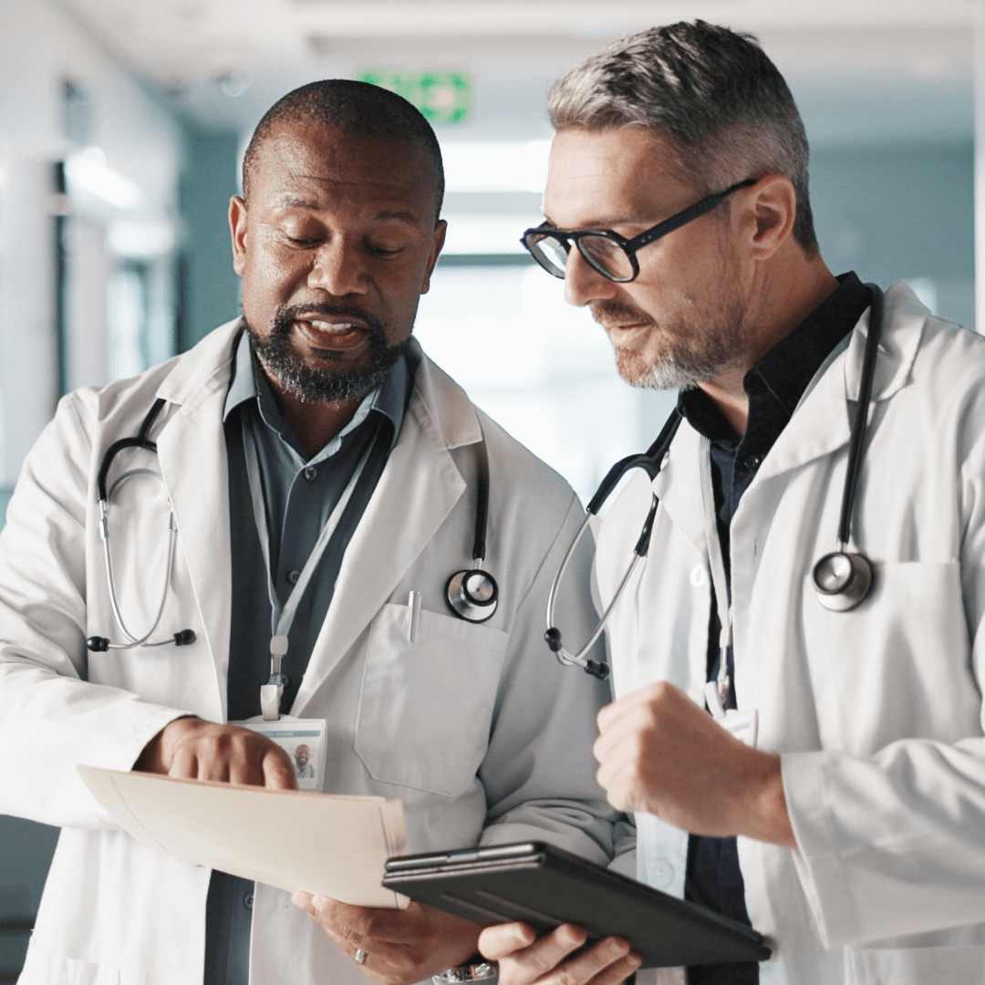 Two surgeons discussing vision care for a patient.